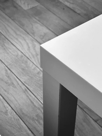 Close-up of a modern black and white Onyx & Oak product displayed on a clean wooden surface.
