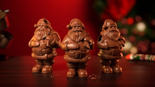 a group of chocolate santa clause figurines on a table