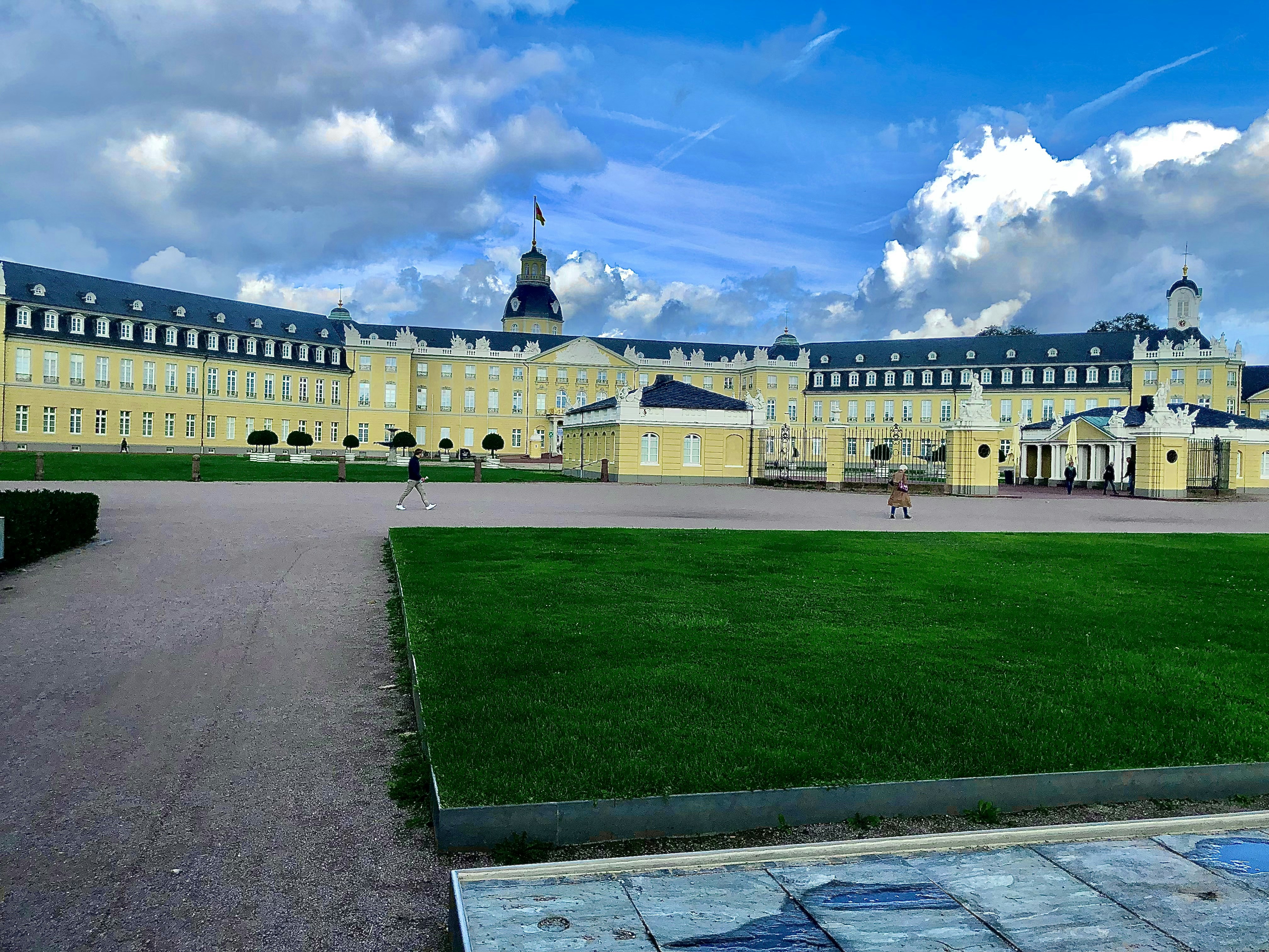 a large building with a green lawn in front of it