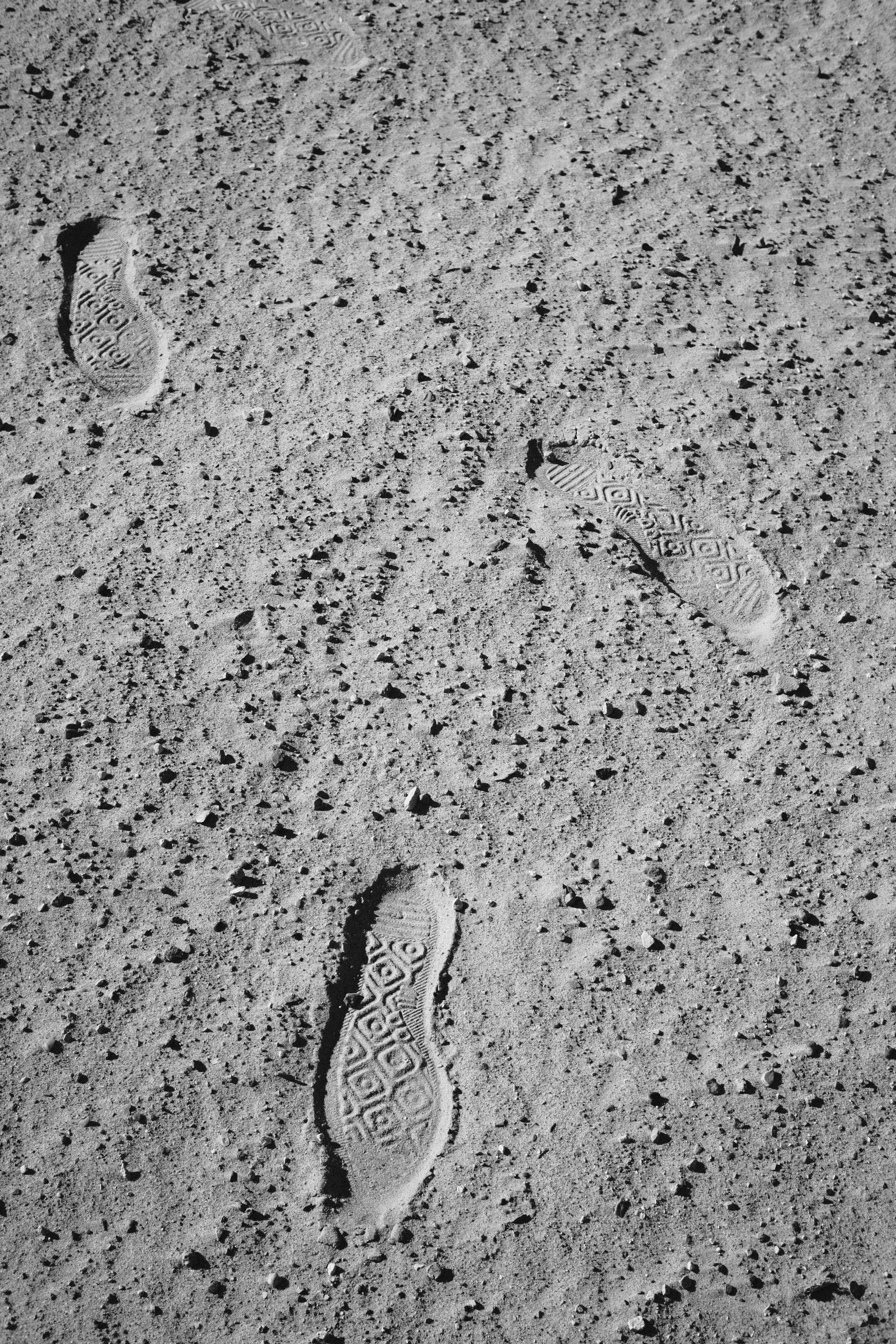 Two footprints in the sand of a beach photo Free Contrast Image on