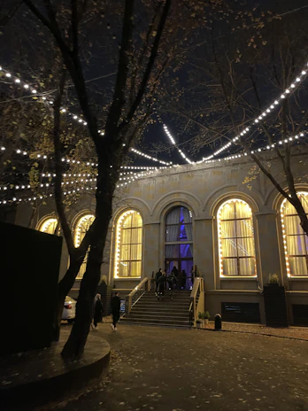 Elegant architectural backdrop with soft lighting highlighting the event venue entrance.