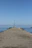Close-up of a sturdy pier cap installed on a wooden pier under a bright sky.