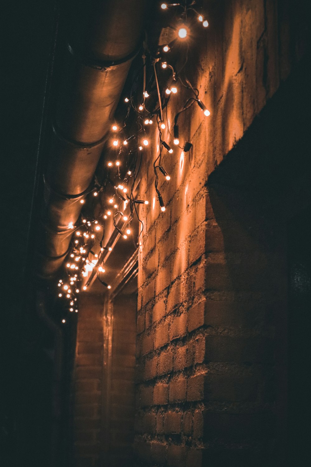 a brick wall with lights hanging from it