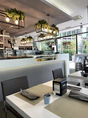 A bustling café interior showcasing elegant table settings and ambient lighting.