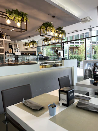 A stylish shot of the café’s inviting seating area bathed in natural light with coffee cups and snacks on tables.