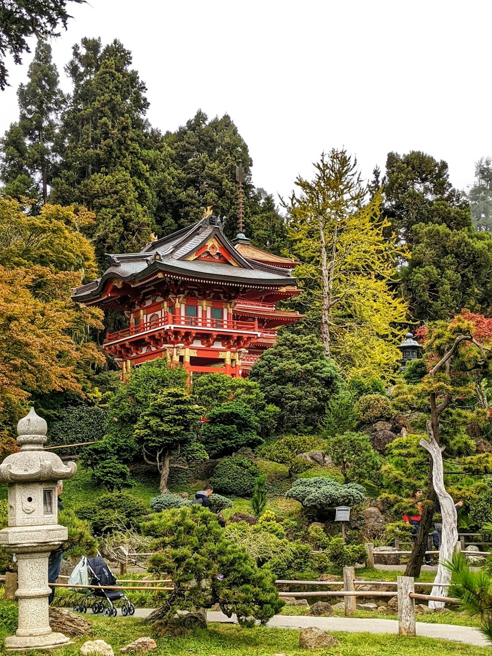 a red building surrounded by trees in a park