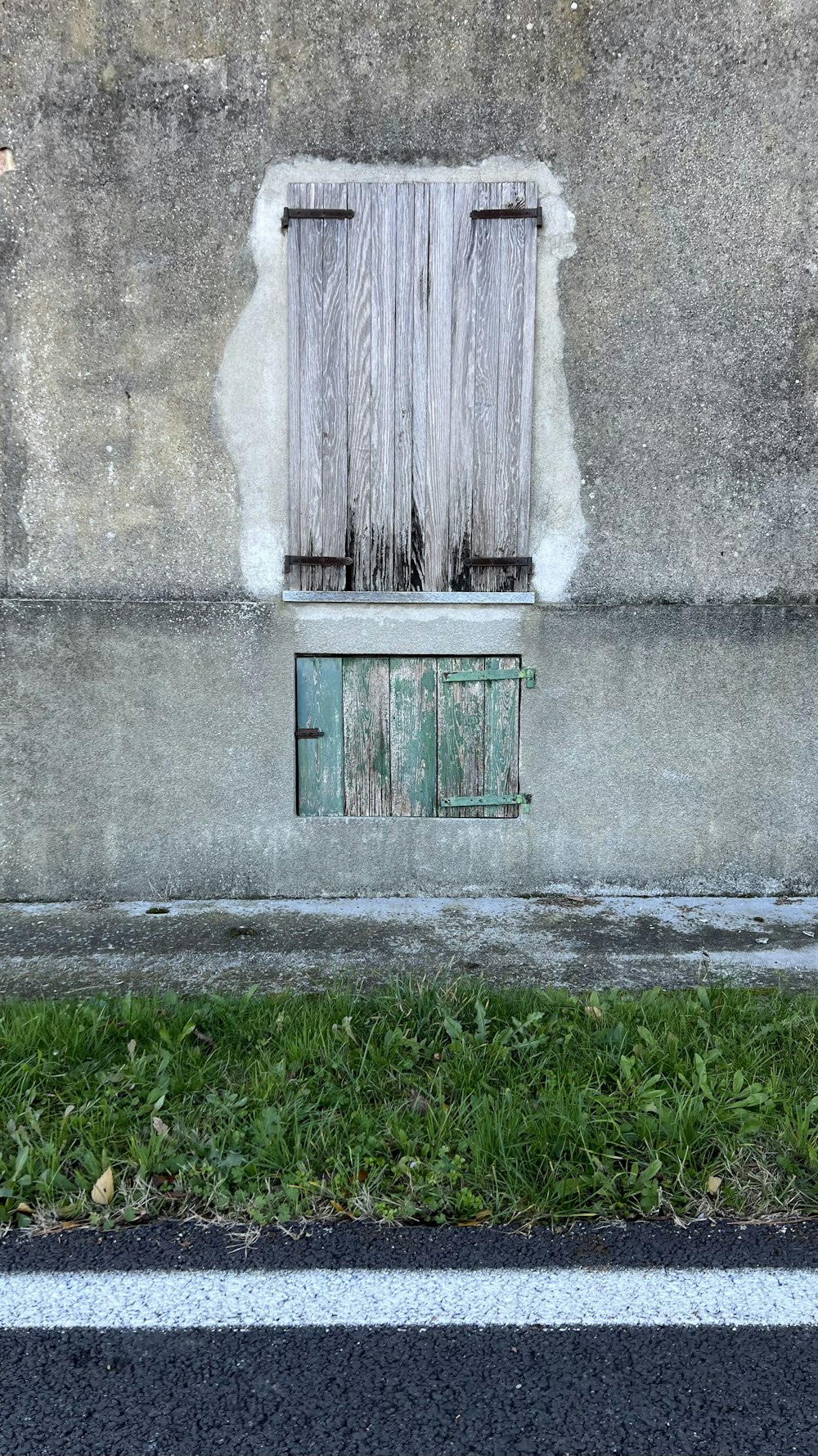 a green fire hydrant sitting next to a building