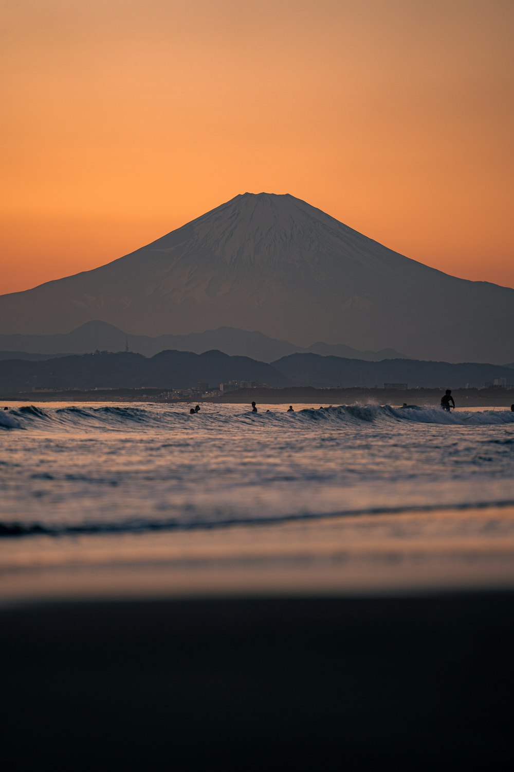 a group of people riding surfboards on top of a wave