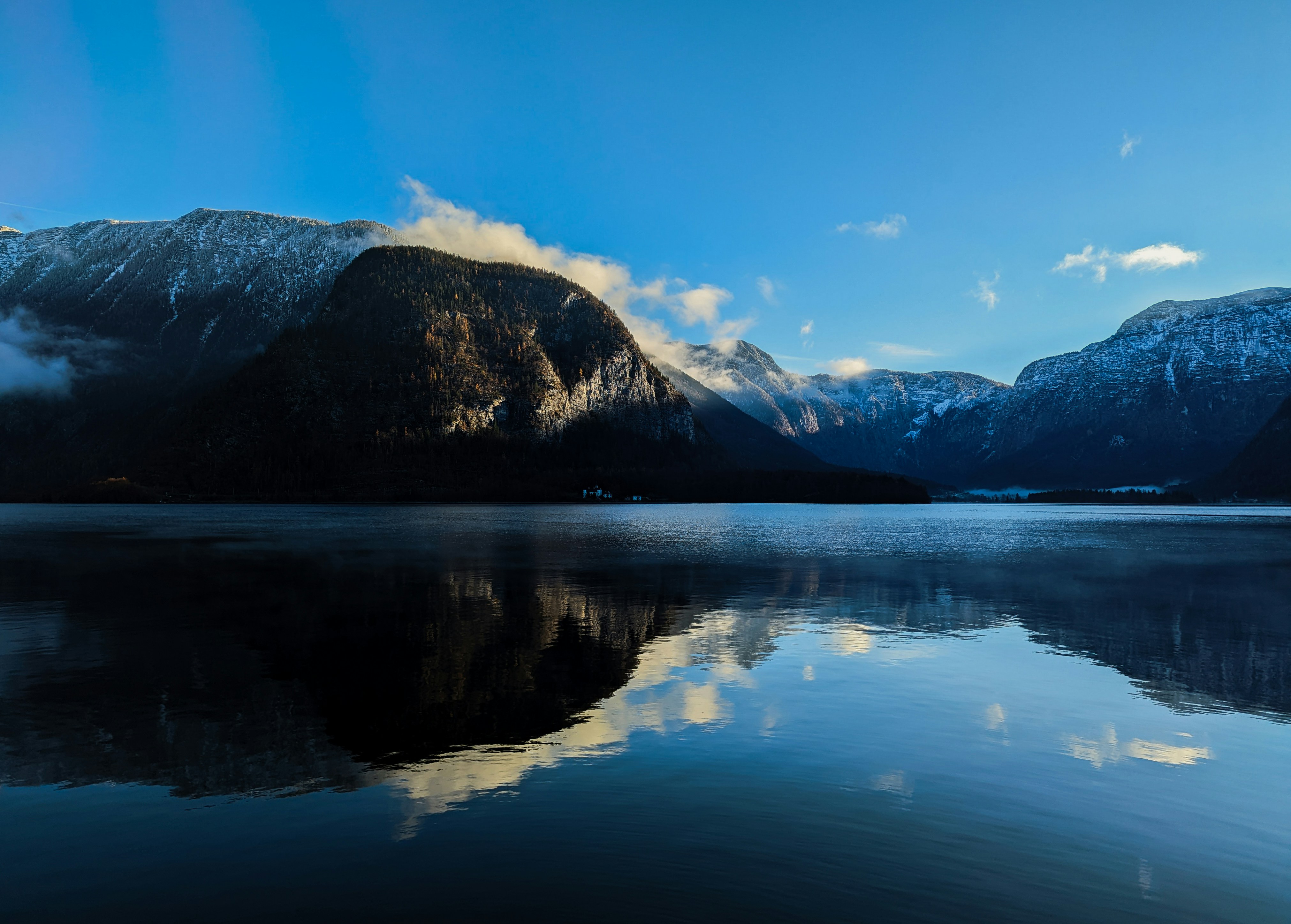 a body of water with mountains in the background, Another morning view of the Lake in Hallstatt. New day and new wether)