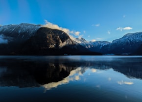 a body of water with mountains in the background