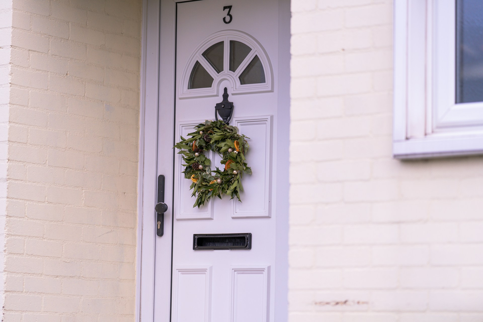 a white door with a wreath on it