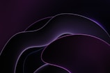 Sleek, abstract shapes blending in dark purple hues from a creative montage.