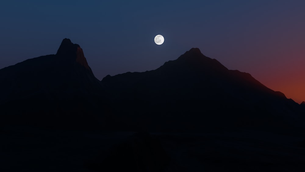 the sun is setting behind a mountain range