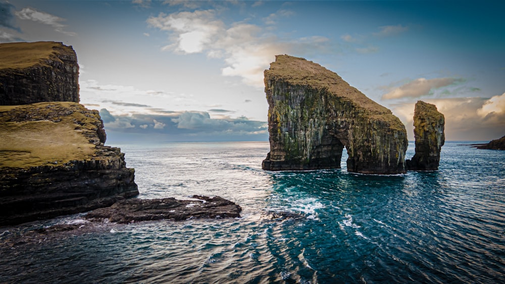 a large rock formation in the middle of the ocean