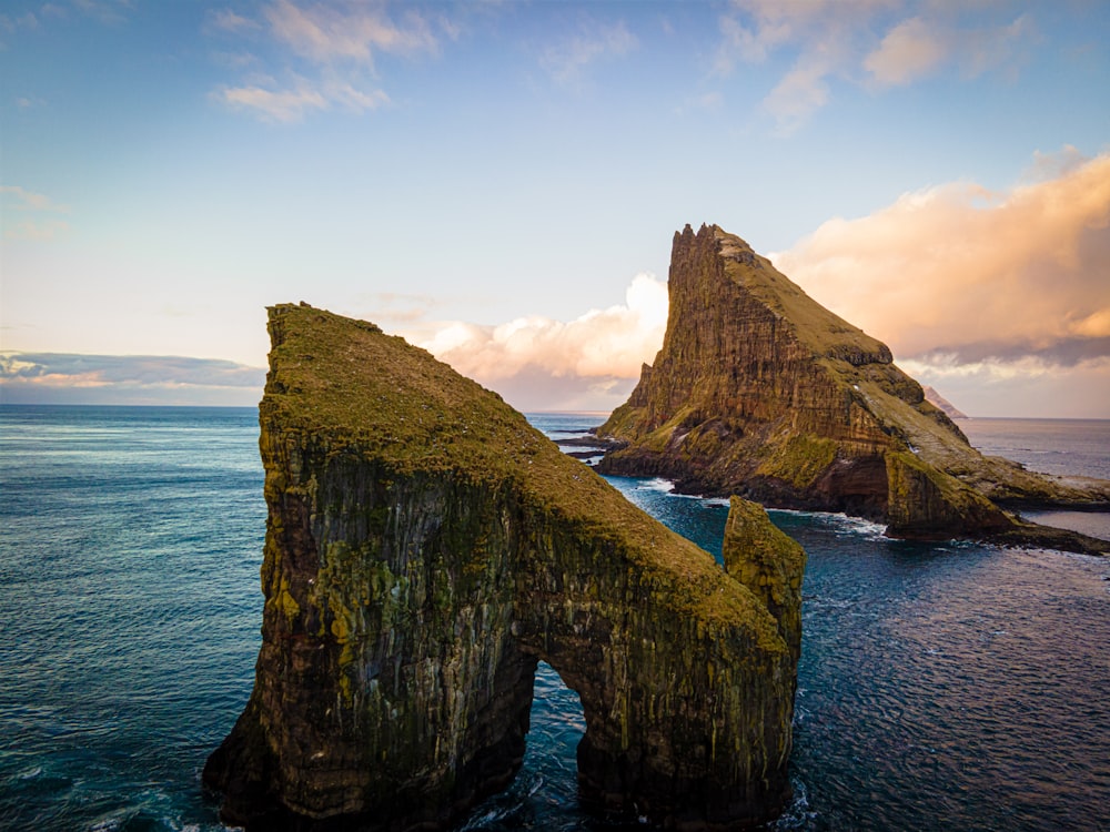 a large rock formation in the middle of the ocean