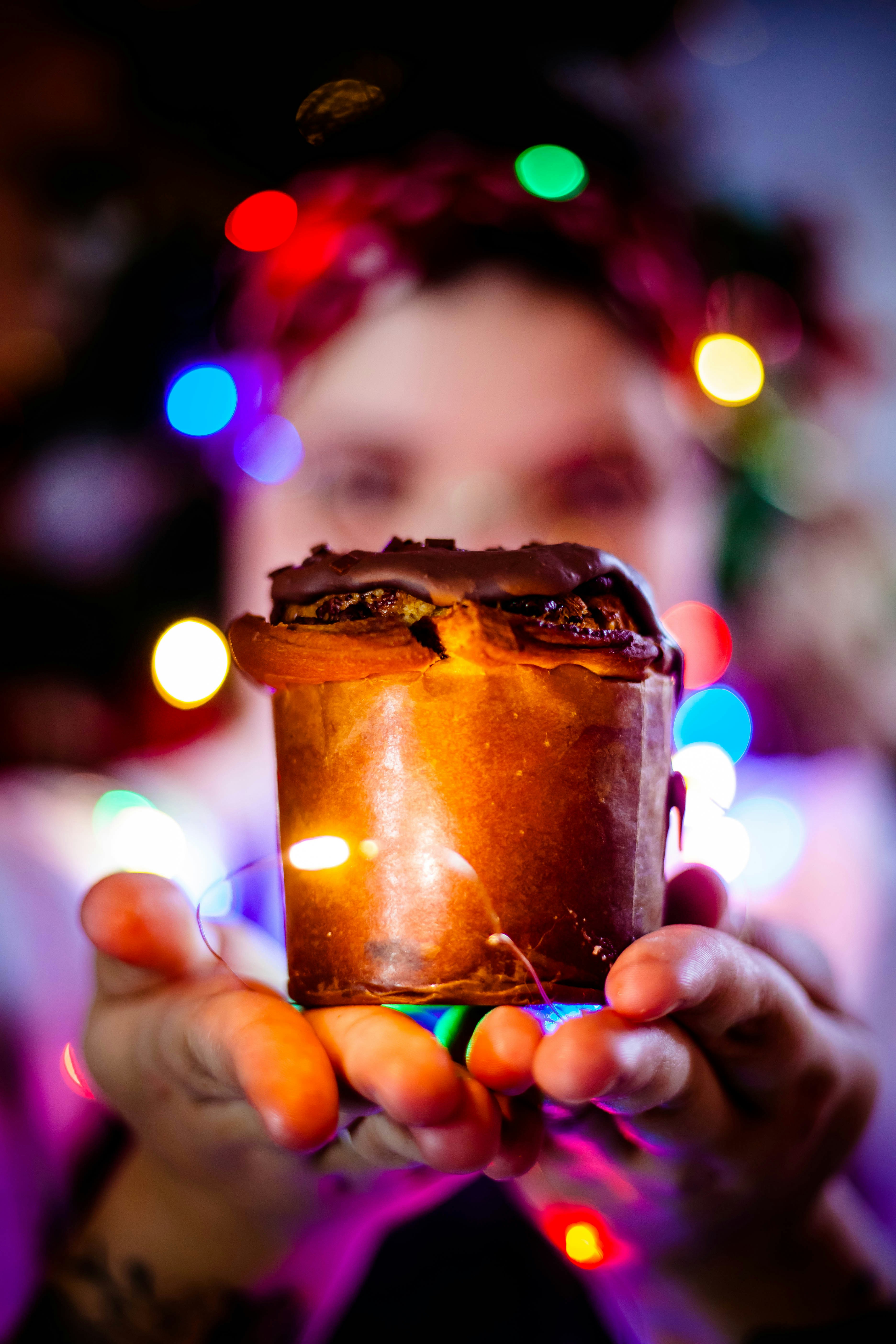 a woman holding a lit candle in her hands