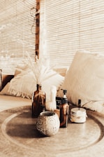 a table topped with bottles and a vase filled with flowers