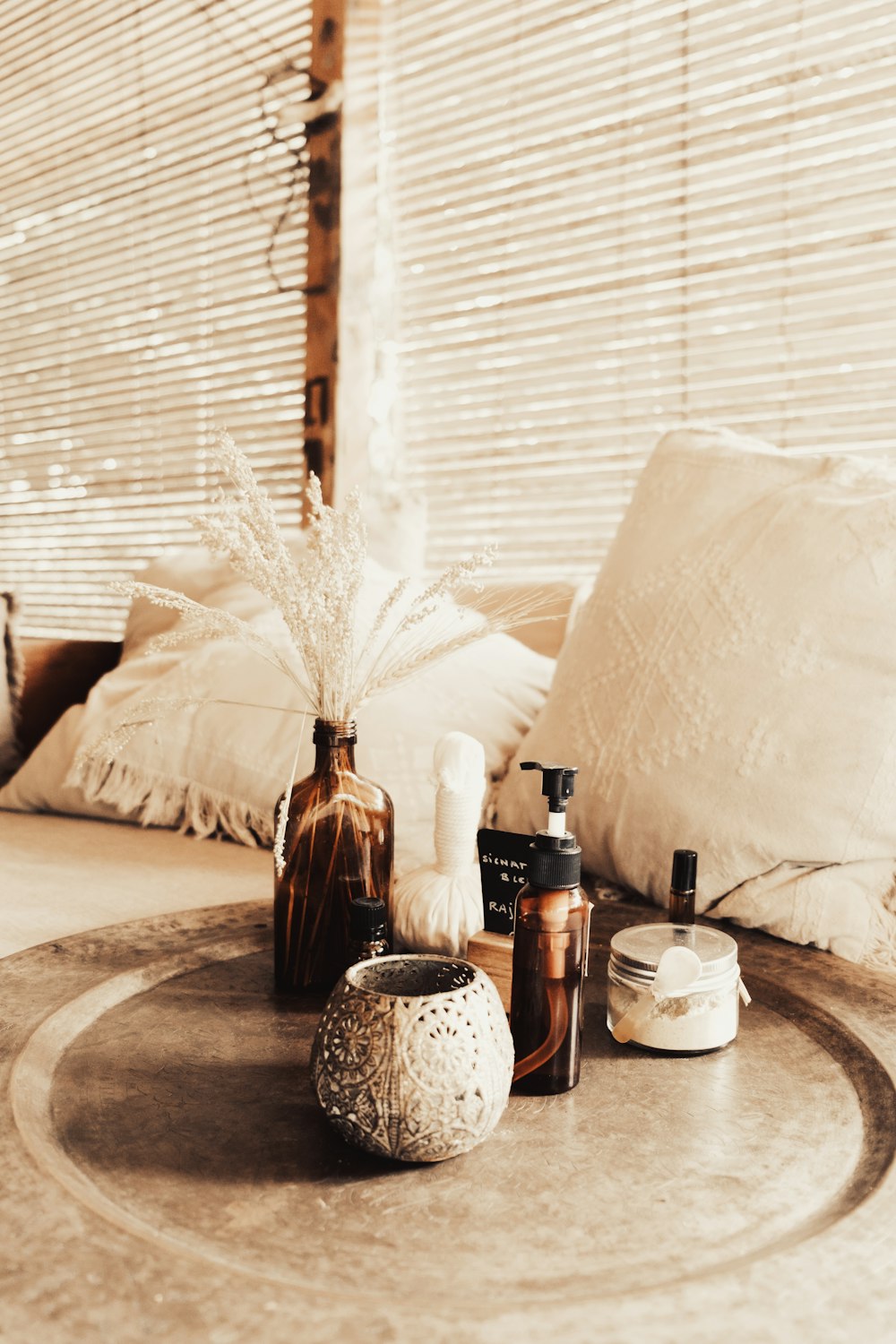 a table topped with bottles and a vase filled with flowers