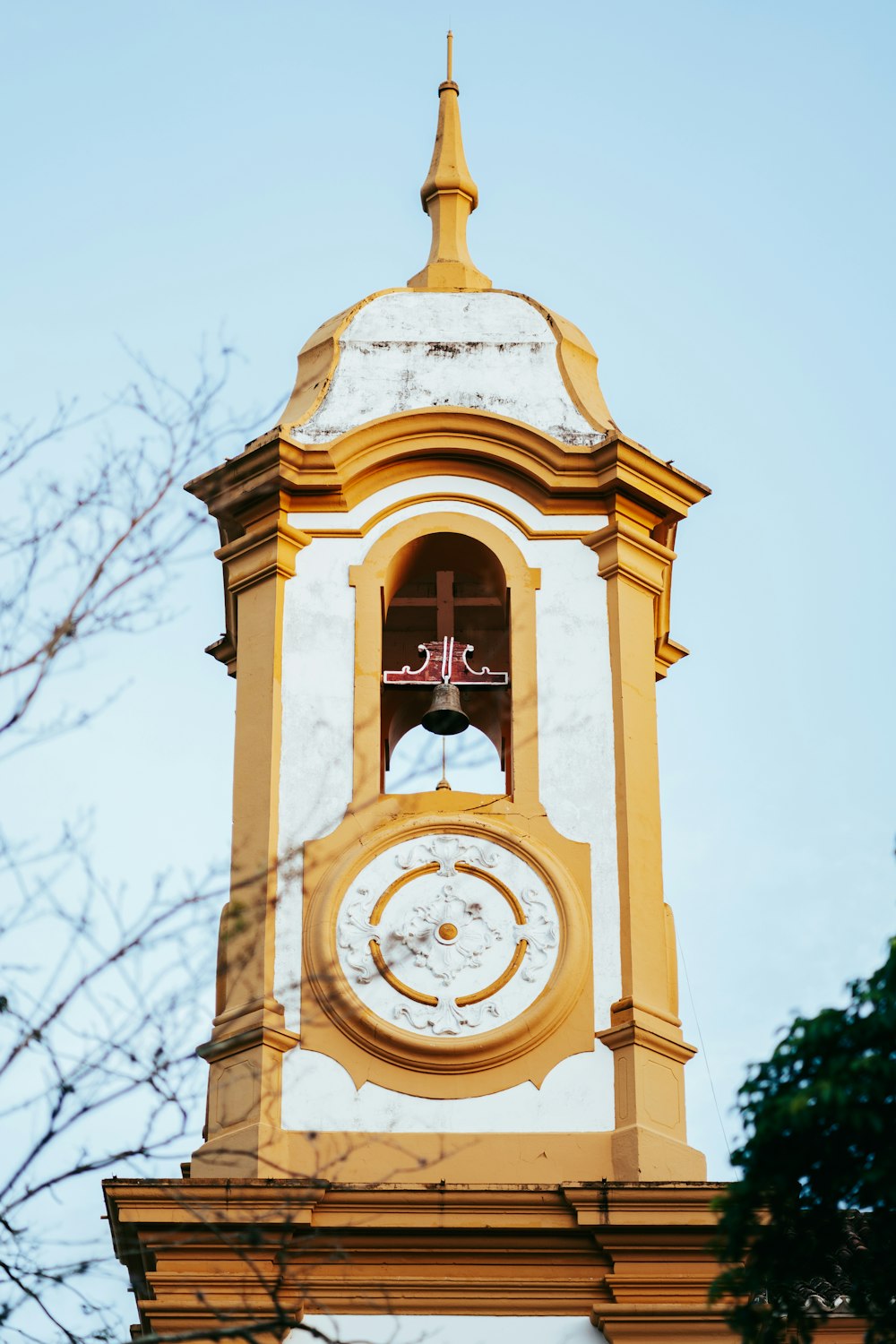 a tall clock tower with a clock on each of it's sides