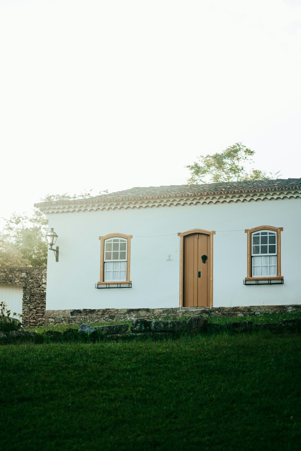 a white house with a brown door and windows