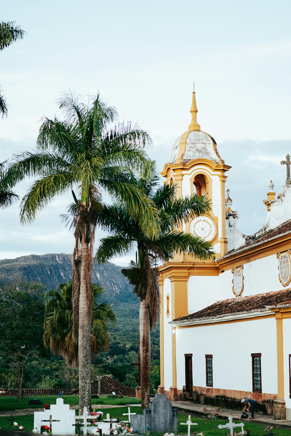 a white and yellow church with a clock tower