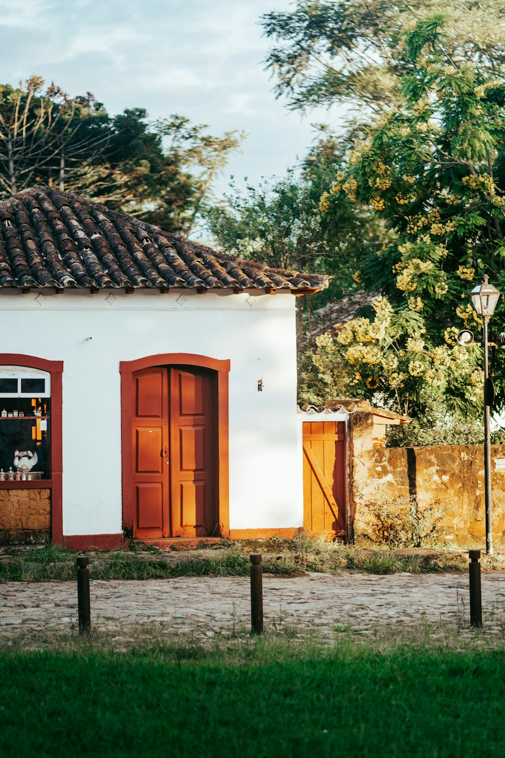 a small white building with a red door