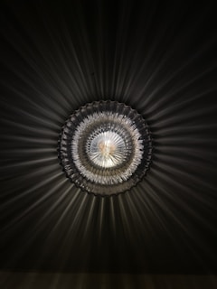 Close-up of a Morning Star ceiling light showcasing its intricate metalwork and frosted glass design.