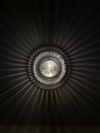 Close-up of a Morning Star ceiling light showcasing its intricate metalwork and frosted glass design.