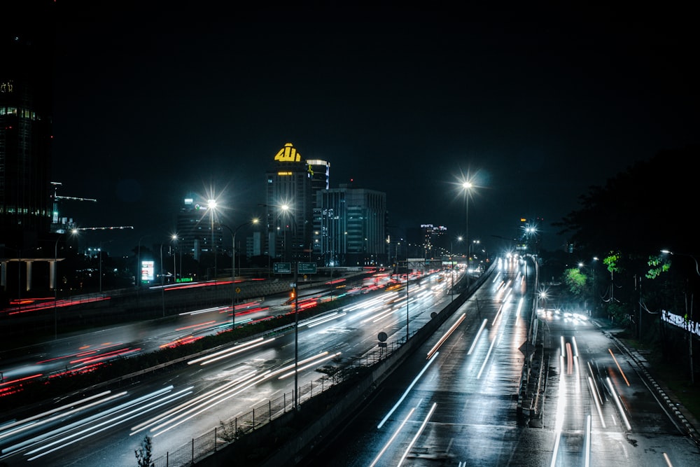 a city street filled with lots of traffic at night