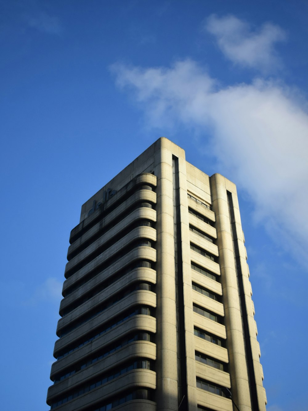 a tall building with a sky background