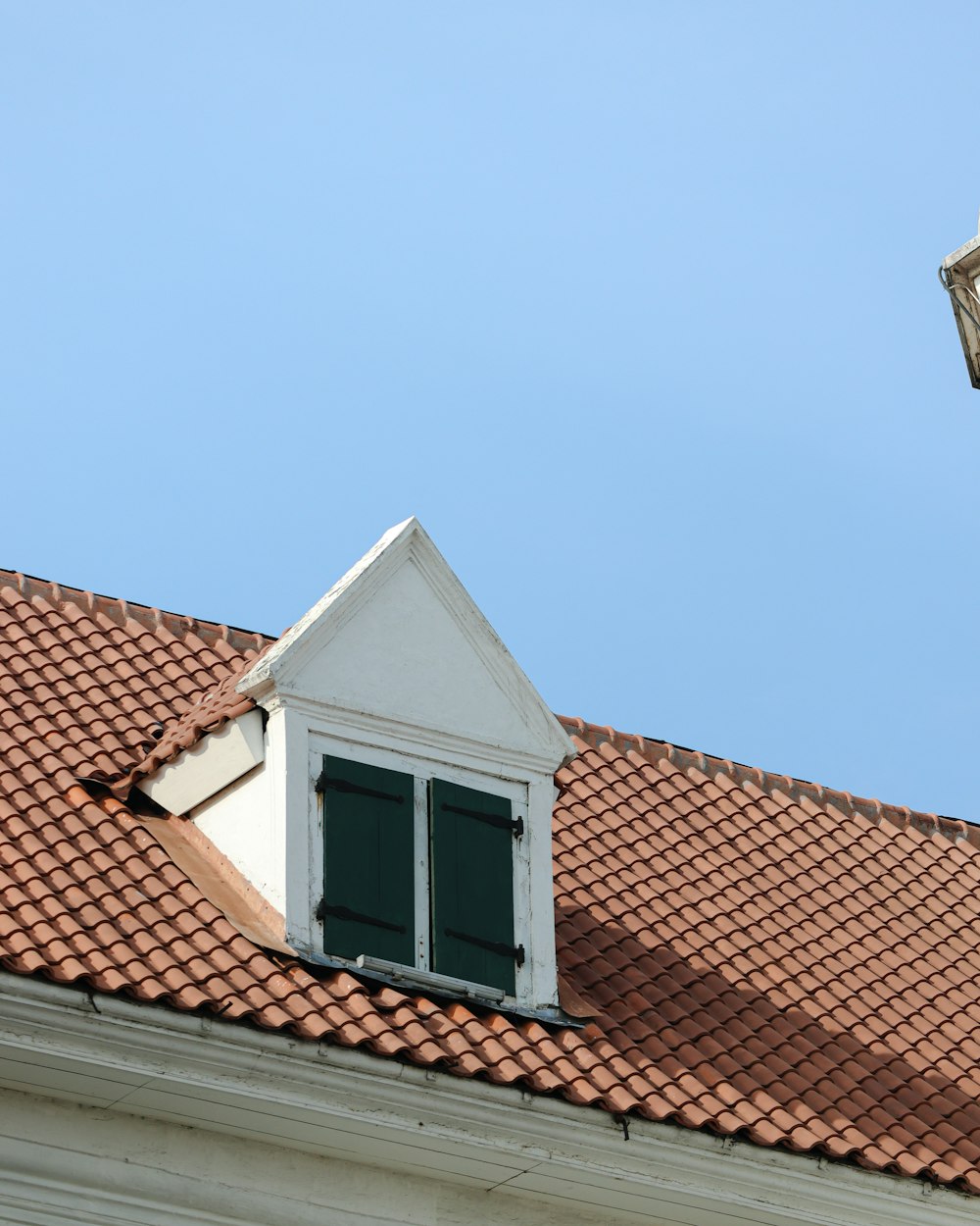 a white house with a red tiled roof