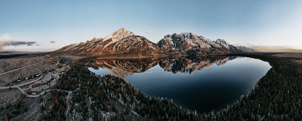 a mountain range with a lake in the foreground