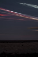 A dynamic night sky with streaks of neon light representing innovation and community empowerment.