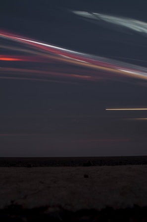 A dynamic night sky with streaks of neon light representing innovation and community empowerment.