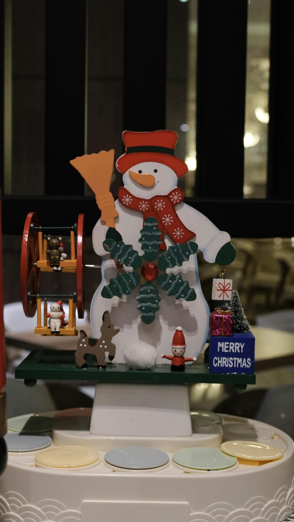 a snowman on a sleigh with christmas decorations