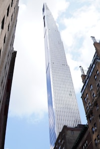 a very tall building towering over other tall buildings