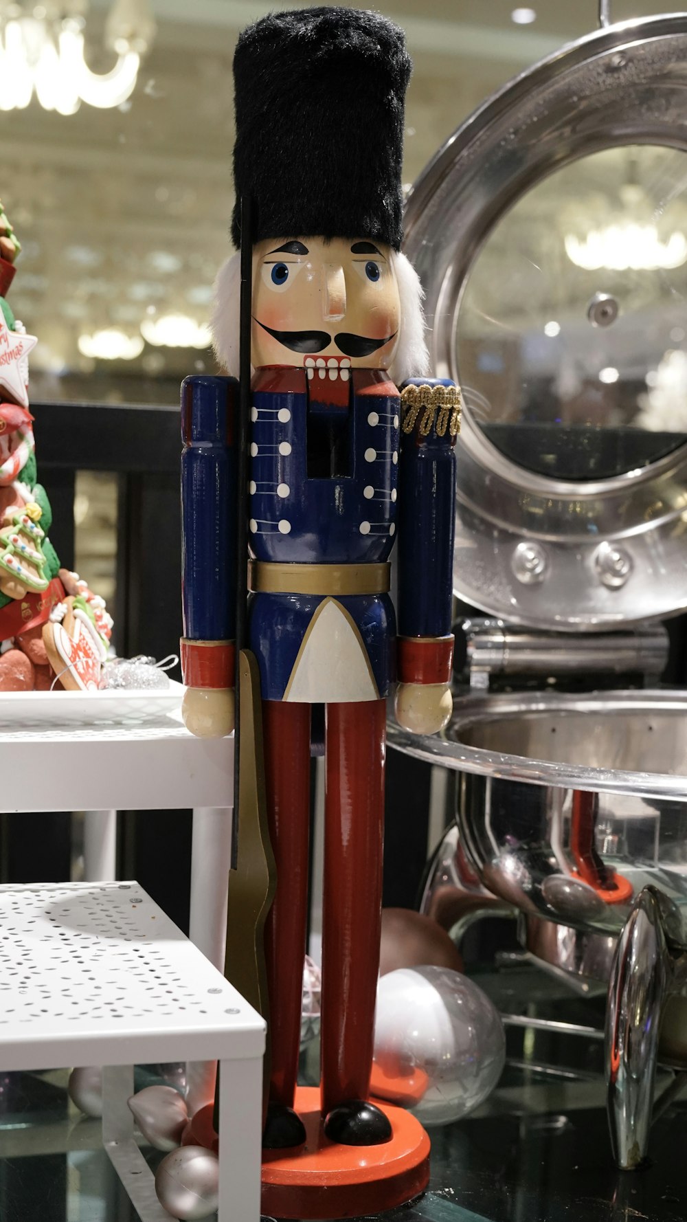 a nutcracker is standing next to a christmas tree