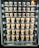 A vending machine filled with rows of brown paper cups, each labeled with different flavors and prices. The cups are neatly organized within clear slots across several rows and columns.
