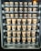 A vending machine filled with rows of brown paper cups, each labeled with different flavors and prices. The cups are neatly organized within clear slots across several rows and columns.