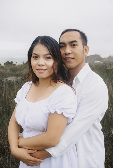 a man and a woman standing in a field