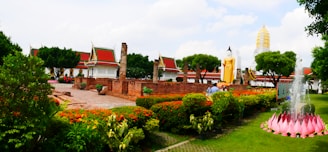 a garden with a fountain in the middle of it