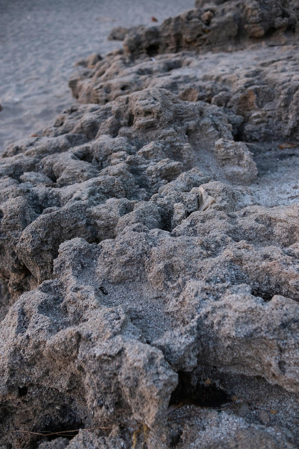 a close up of a rock formation on a beach