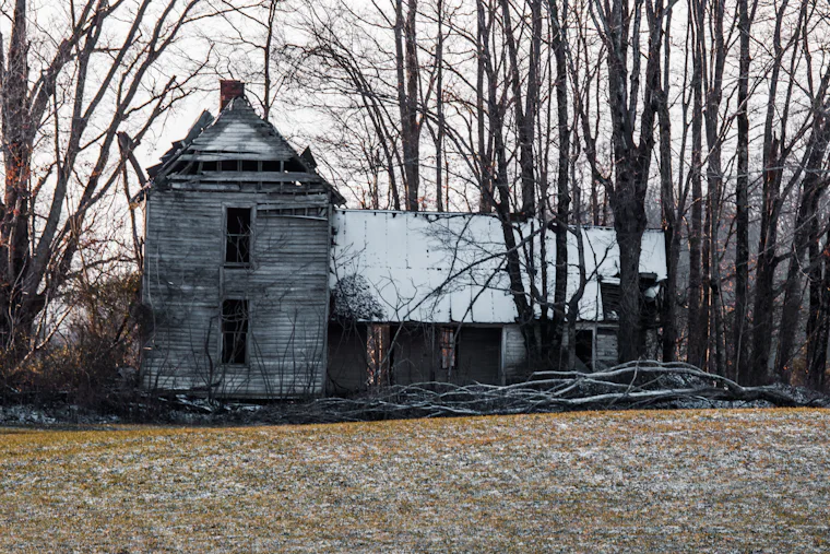 Country farmhouse across an open field