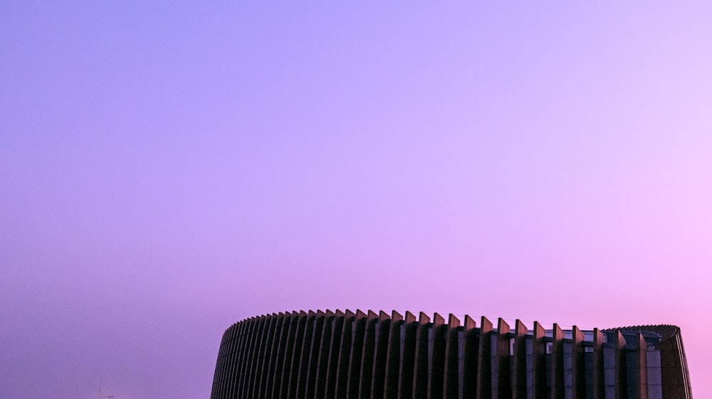 a tall building with a sky in the background