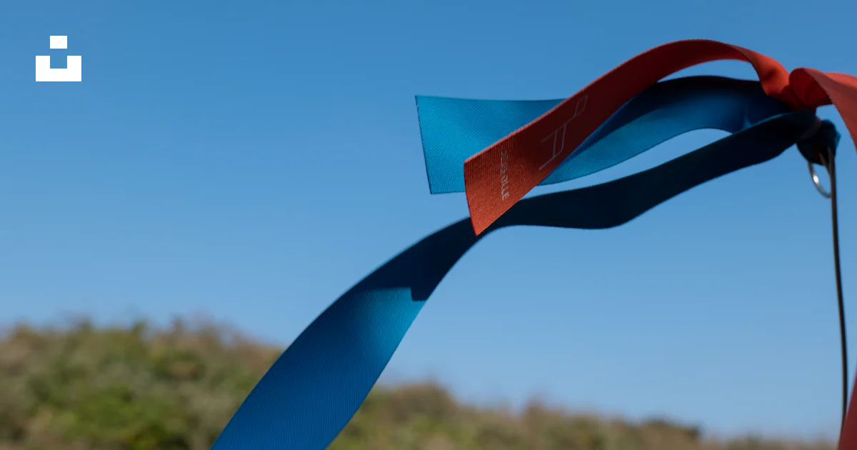 A red and blue ribbon is flying in the air photo – Free South korea ...