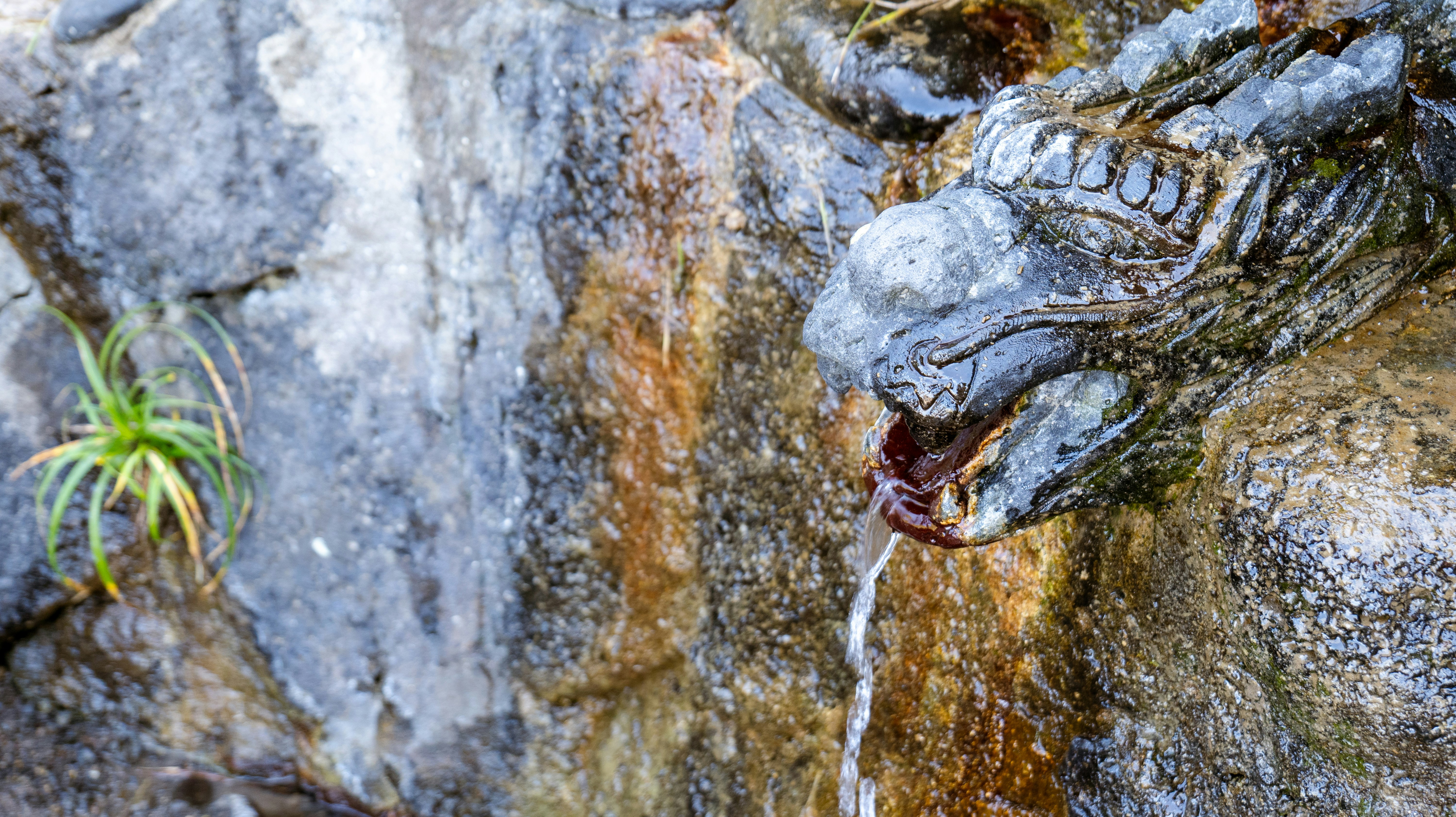 Close-up of a cascading waterfall over sculpted rock