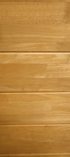 Several horizontal wooden planks with a smooth finish and natural grain patterns.