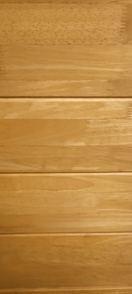 Several horizontal wooden planks with a smooth finish and natural grain patterns.