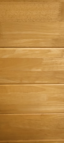 Several horizontal wooden planks with a smooth finish and natural grain patterns.