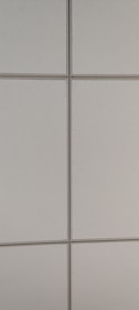 A pattern of rectangular, light-colored ceiling tiles with small perforations and visible grid lines.